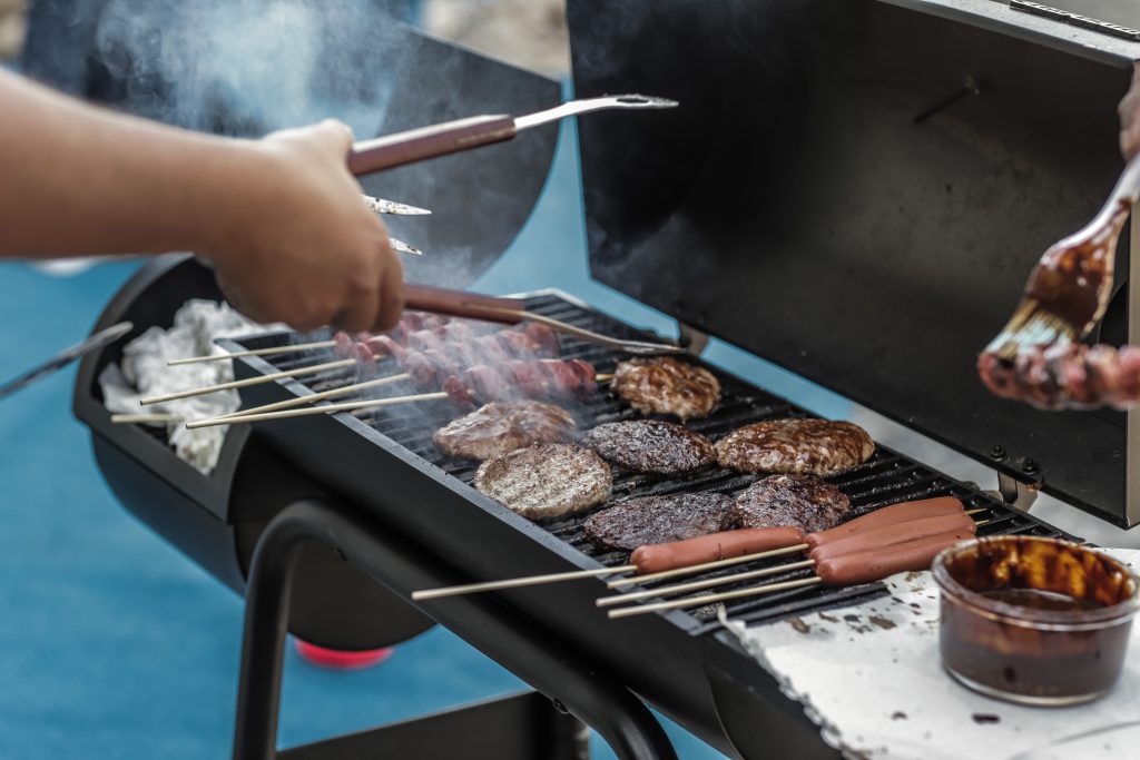 person-grilling-sausage-and-meat-1857732-1-1024x683