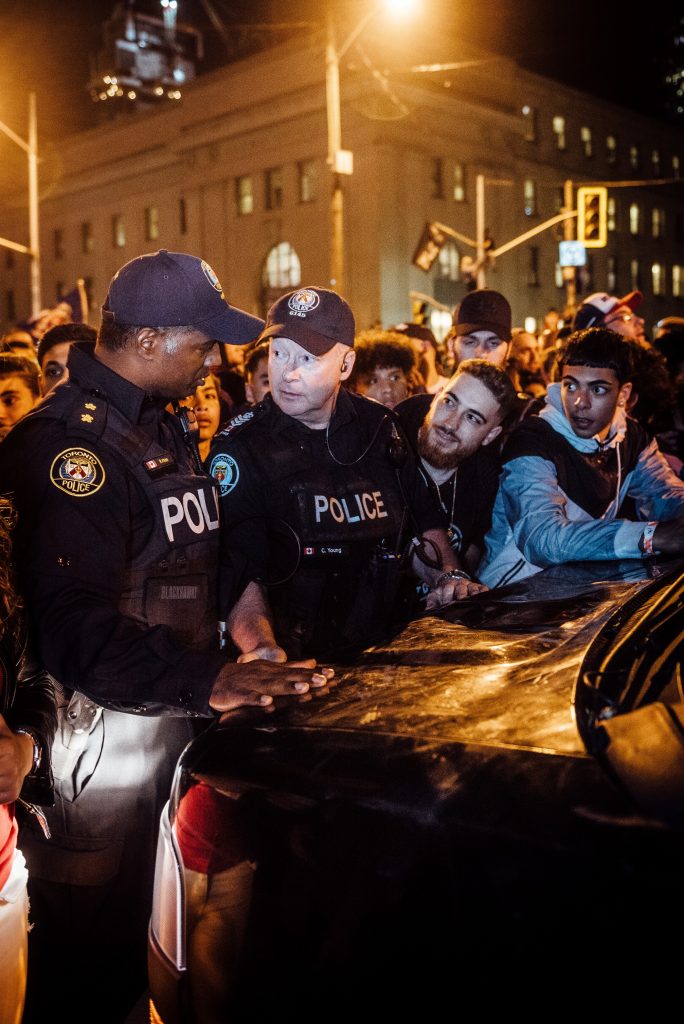 police-men-with-a-group-of-people-in-a-rally-2834169-684x1024